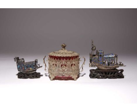 TWO CHINESE SILVER FILIGREE AND ENAMEL PLEASURE BOATS19TH CENTURYEach raised on a wood stand carved as waves, together with a