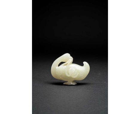 A CHINESE CELADON JADE CARVING OF A GOOSEQING DYNASTY OR LATERStanding holding a lotus stem in its beak, 7.4cm.