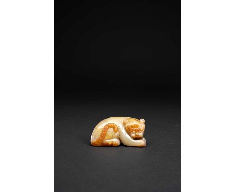 A CHINESE CELADON JADE CARVING OF A RECUMBENT TIGERQING DYNASTYThe crouching feline with its head turned to the right, incise