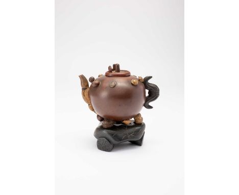 A CHINESE YIXING TEAPOT AND COVER 18TH/19TH CENTURYThe globular body applied with various seed pods and nuts, the handle and 