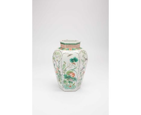 A CHINESE FAMILLE VERTE HEXAGONAL VASELATE QING DYNASTYPainted with birds and insects amidst flowers and foliage, a six chara