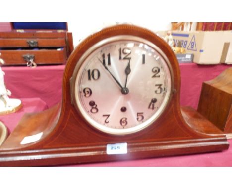 A mahogany mantle clock with three train German movement striking the hours and chiming on tubular gongs. 9½' high