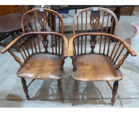 A pair of 19th century yewwood Windsor elbow chairs on ring turned splayed legs with crinoline stretchers