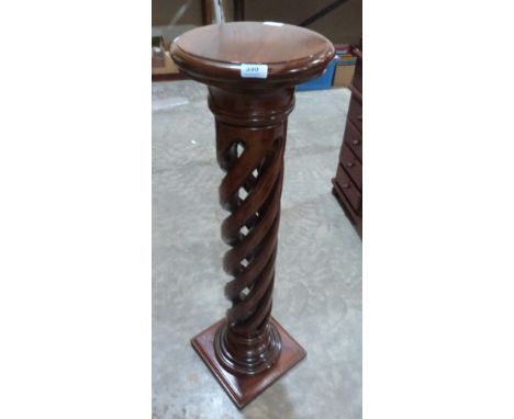 A mahogany jardiniere stand with openwork column