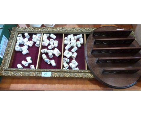 A collection of 56 ceramic thimbles with two display stands