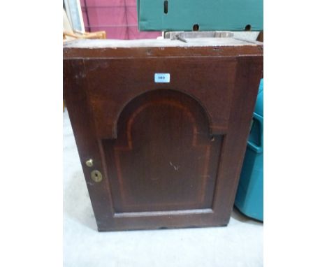 An 18th century oak hanging wall cupboard, the arch fielded and banded door enclosing shelves and two drawers 21' wide