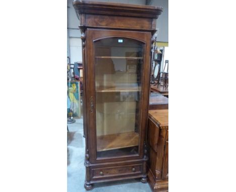 An American oak display cabinet enclosed by a bevel glazed door over base drawer. 31' wide