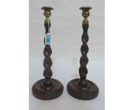 A pair of late 19th century oak barleytwist turned candlestick with brass sconces. 14' high