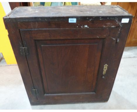 An 18th century oak hanging cupboard enclosed by a fielded panel door. 26½' wide