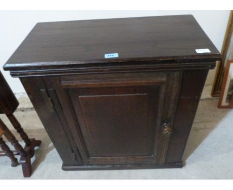 An 18th century oak hanging wall cupboard enclosed by a fielded panel door. 24½' wide