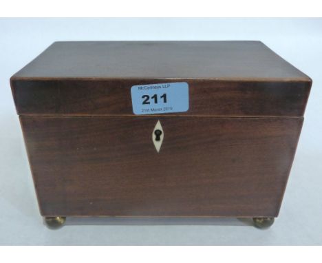 A Regency mahogany and line inlaid tea caddy on gilt brass ball feet. 8' wide. Interior gutted