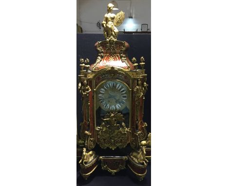 A large boulle bracket clock
With bracket, the domed top surmounted a female warrior, the dial with black Roman numerals flan