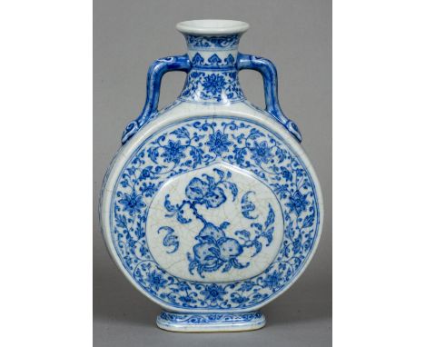 A Chinese blue and white porcelain twin handled moon flask Decorated with peach vignettes within a lotus strapwork ground, bl