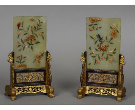 A pair of Chinese hardstone mounted jade table screens
Each with floral decorations mounted in gilt painted pierced carved wo