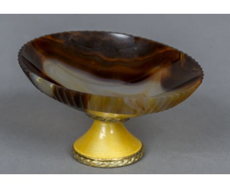 A 19th century Continental yellow metal and enamel mounted carved agate dish
The bowl with fluted rim, supported on a spreadi