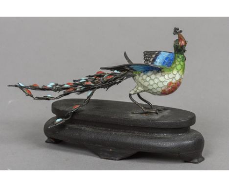 A Chinese unmarked white metal filigree and enamel model of a peacock
Typically modelled with turquoise and coral cabochon se