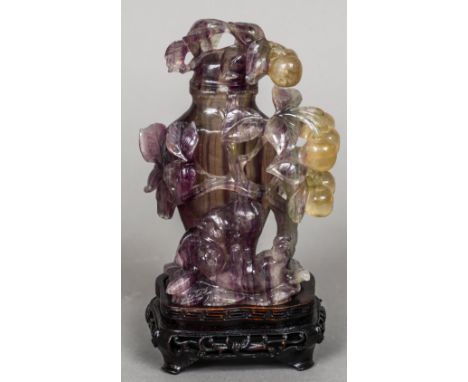A Chinese carved hardstone censor and cover
Modelled amongst foliage with two playing kittens to the base, mounted on a pierc
