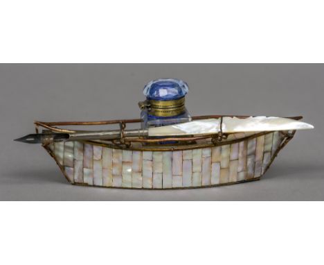 A late 19th century souvenir mother-of-pearl desk stand formed as a boat
Inscribed Biarritz; together with a mother-of-pearl 