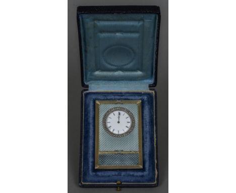 A small rose diamond set silver gilt mounted blue guilloche enamel desk clock
The white enamelled dial with Roman numerals, t