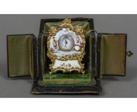 A miniature Swiss desk clock
Decorated with enamelled figural vignettes, housed in a plush lined travelling case.  6 cm high.