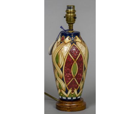 A modern Moorcroft pottery table lamp
With stylised Arts & Crafts decoration.  31 cm high. CONDITION REPORTS: Generally in go