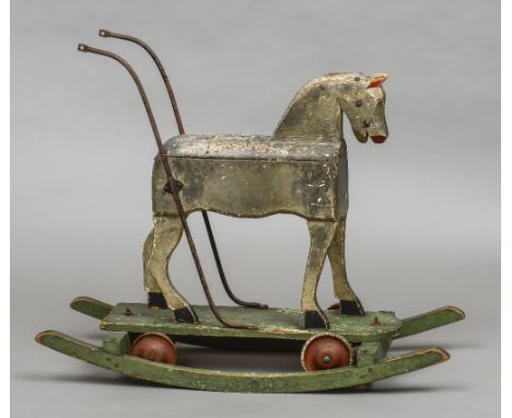 A late 19th/early 20th century painted pine rocking horse
The rocking section with bolted removable platform mounted with whe