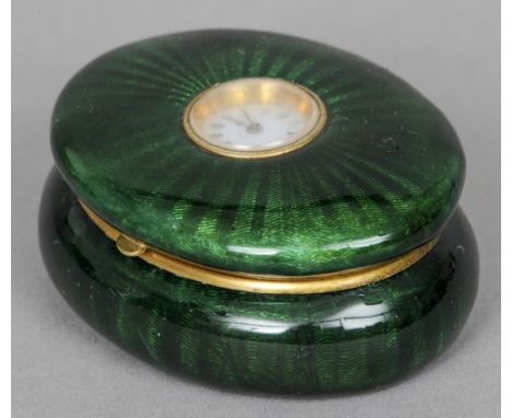 A Continental enamel watch set box
Of oval form, the hinged lid inset with a watch with white dial and Roman numerals, the in