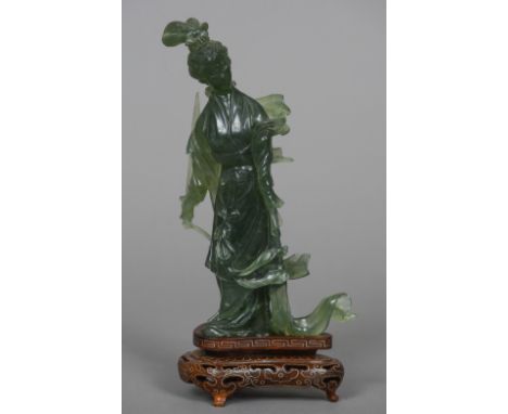 A Chinese carved jade figure Guanyin
Typically modelled holding a sword, mounted on a white metal inlaid carved and pierced s