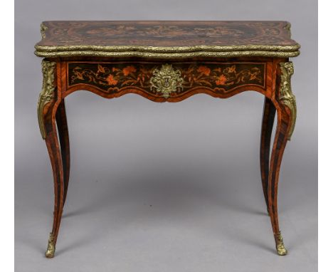 A 19th century marquetry card table
The shaped hinged top with floral inlays, enclosing a baize lined playing surface and wit