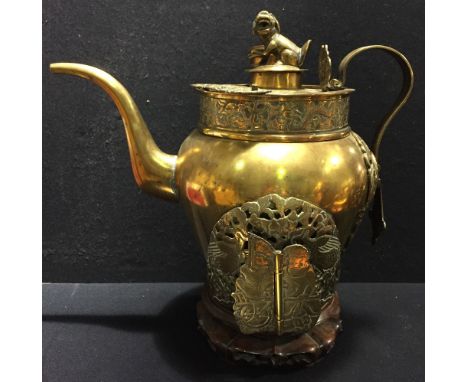 An antique Chinese copper and brass street vendor's tea kettle
With dog-of-fo finial, scroll handle and variously pierced and