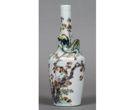 A Chinese porcelain bottle vase
The slender neck encompassed by a dragon, the main body with bamboo and prunus blossoms, the 