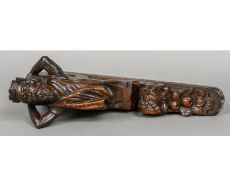 A 19th century carved oak bracket
Worked with a figurehead wearing a crown, acanthus sprays, scrolls and ribbon tied fruiting