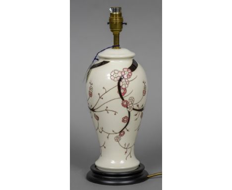 A modern Moorcroft pottery table lamp
Of waisted cylindrical form, decorated with pink flowers on a white ground.  36.5 cm hi