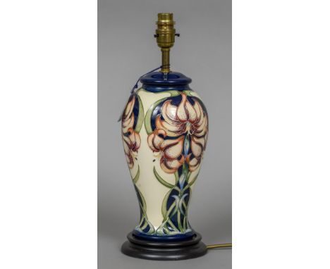 A modern Moorcroft pottery table lamp
Of waisted cylindrical form, with Art Nouveau stylised floral decoration.  37.5 cm high