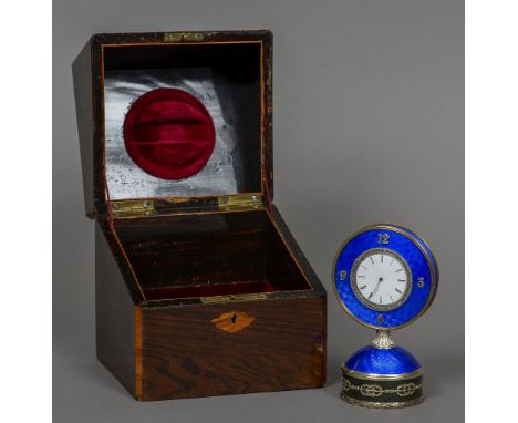 A rose diamond set silver mounted enamel desk clock
The white enamelled dial bordered by a row of small diamonds over a blue 