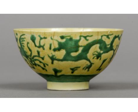 A Chinese Imperial yellow ground bowl
Decorated in the round with green dragons and phoenix, the underside with six character