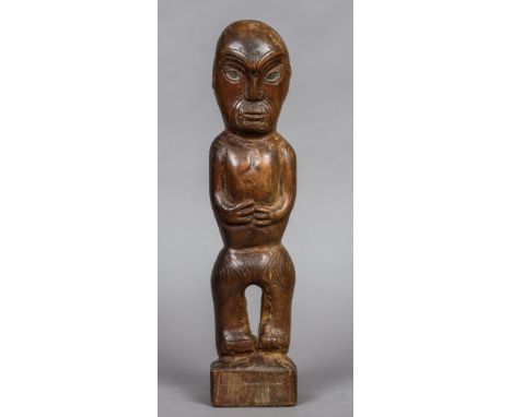 A 19th century Maori carving, probably a house post
With typical carved tattoo decorations and with inset mother-of-pearl eye
