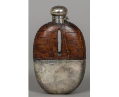 A Victorian silver and crocodile skin hip flask, hallmarked Sheffield 1894, maker's mark of Walker & Hall
Of typical oval for