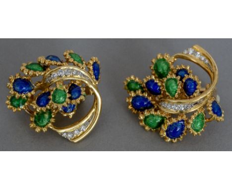 A pair of Kutchinsky 18 ct gold ear clips
Each set with a band of diamonds and with blue and green enamel decorations.  Each 