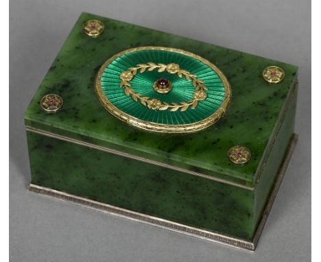 A ruby set silver and enamel mounted spinach jade box
Of hinged rectangular form, the lid centred with a green guilloche enam