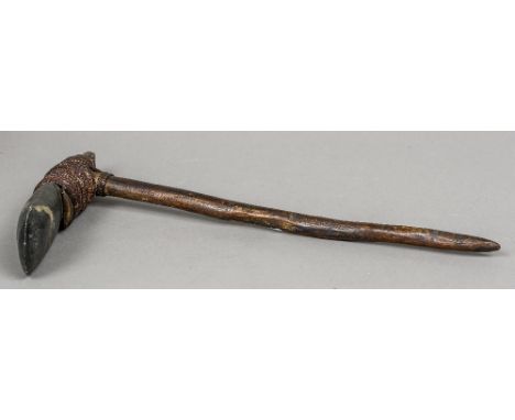 A Maori axe
Of typical form.  The shaft 46.5 cm long.  CONDITION REPORTS: Some splits and chipping to shaft, some general sur