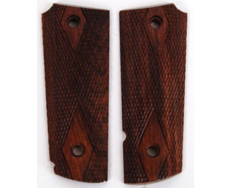 COLT 45: A pair of Colt 45 pistol gun walnut grips. Each intricately carved.