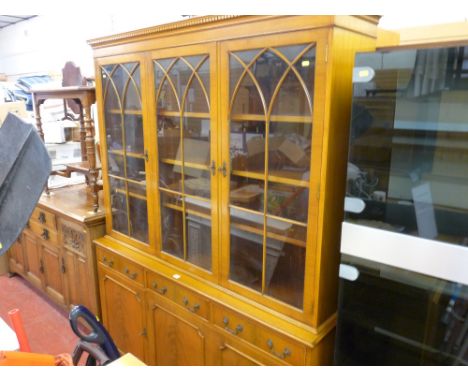 Modern compact light wood dresser with three upper glazed doors over three base cupboards and drawers