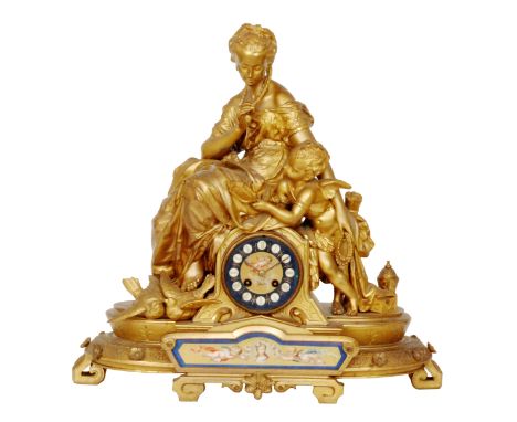 A 19th Century French gilt metal eight day strike figural mantle clock the Serves style porcelain dial above conforming trans