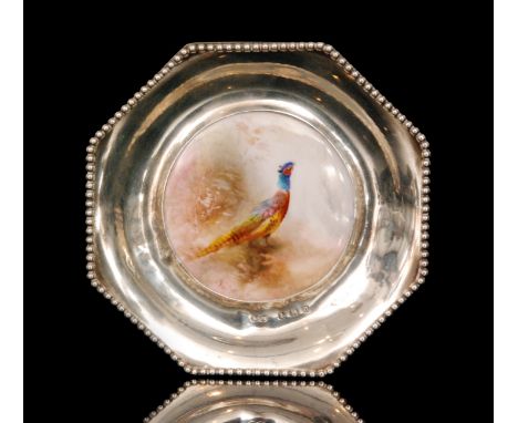 A small octagonal pin dish inset with a Royal Worcester roundel decorated by James Stinton with a hand painted pheasant set t