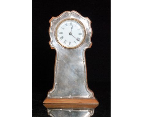 An early 20th Century mahogany and white metal fronted eight day mantle clock, Roman numerals to a circular dial above rectan
