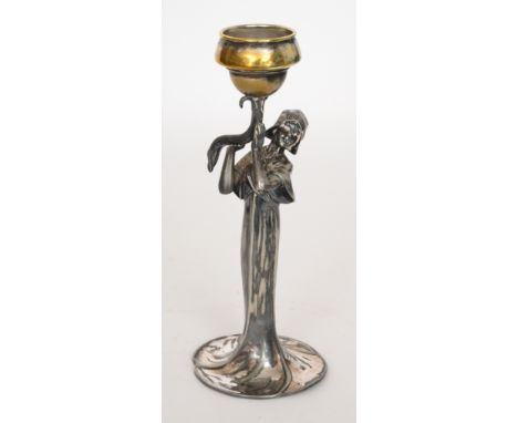 An Art Nouveau polished pewter candlestick modelled as a standing woman holding a stylised flower head, height 26cm. 