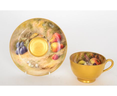 A Royal Worcester fruit painted teacup and saucer decorated by Ricketts, the cup interior with hand painted apples, blackberr