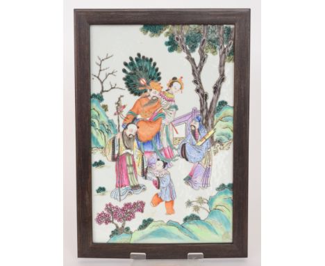 A Chinese hardwood framed porcelain panel decorated with three robed male figures carrying a staff, ruyi sceptre and a scroll