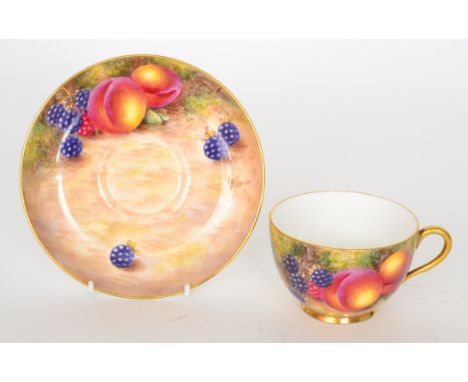 A Royal Worcester fruit painted teacup and saucer decorated by Freeman, the cup with hand painted apples and cherries, the sa